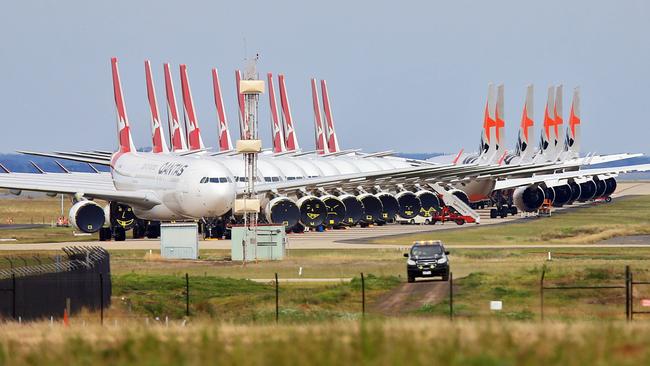 Qantas and Jetstar jets grounded at Avalon Airport. Flights from Melbourne have been severely affected by the crisis, leading to massive job cuts at Australia’s biggest airline. Picture: Aaron Francis