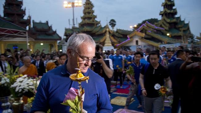 Manager of English club Leicester City Claudio Ranieri, center participates in Buddhist religious rituals.
