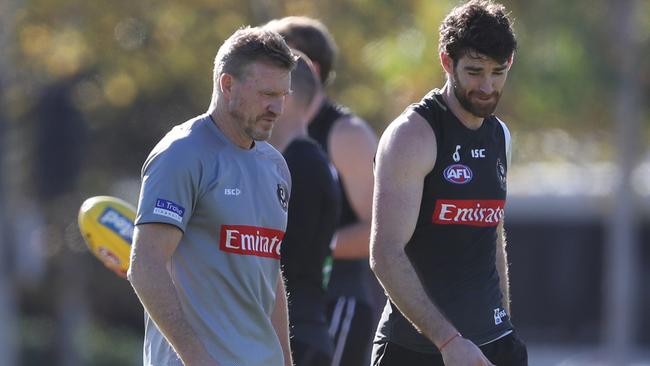 Tyson Goldsack chats to Collingwood coach Nathan Buckley at training. Picture: AAP Images