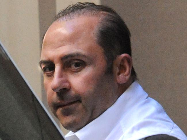 Underworld figure Tony Mokbel is lead into a prison van at the Supreme Court in Melbourne, Tuesday, Oct 18, 2011. Mokbel has applied to change his plea on drugs charges from guilty to not guilty. (AAP Image/Julian Smith) NO ARCHIVING