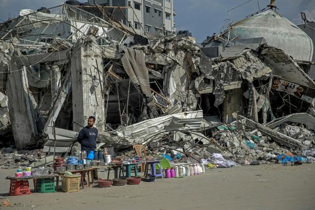 A vendor waits for customers along a street in Gaza City, in the north of the besieged Hamas-ruled territory