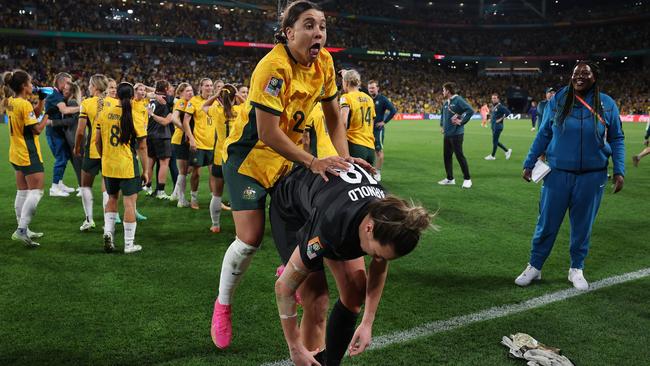 Sam Kerr celebrates the win with Mackenzie Arnold. (Photo by Elsa - FIFA/FIFA via Getty Images)