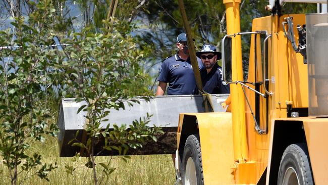 The toolbox is carried away by an excavator after being pulled from the water.