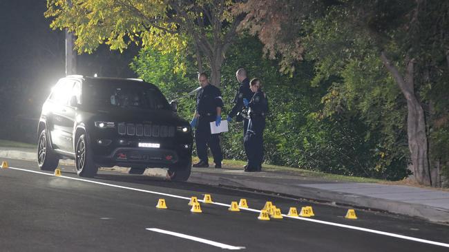 Police mark the bullet casings on Charles St. Picture: Bill Hearne