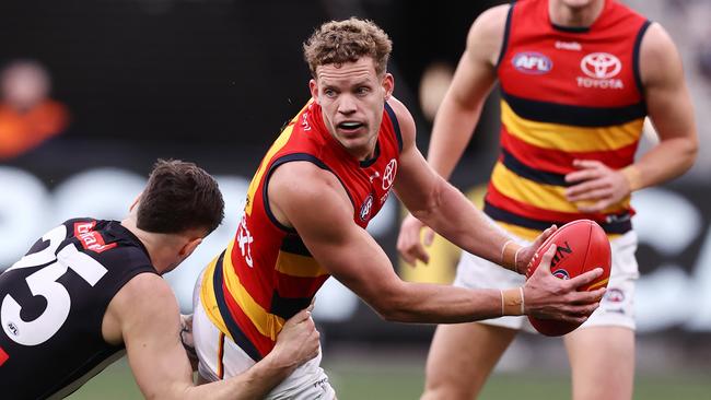 MELBOURNE - June 25 : AFL.   Mitchell Hinge of the Crows looks to give as he is tackled by Jack Crisp of the Magpies  during the round 15  AFL match between Collingwood and Adelaide at the MCG on June 25, 2023, in Melbourne.  Photo by Michael Klein.