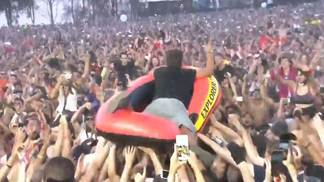 Revellers use a blow-up dinghy to crowd-surf during the Defqon. 1 festival. Picture: Q-Dance