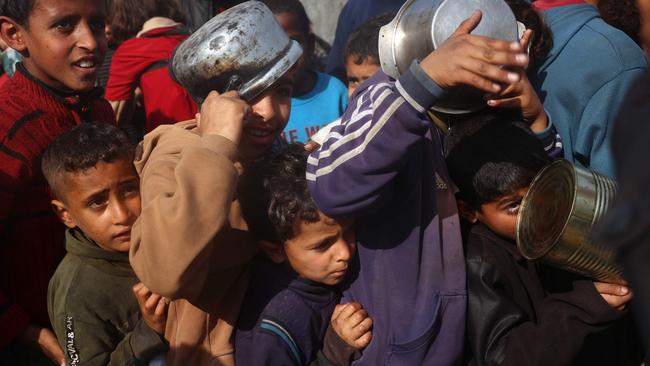 Palestinian children gather to receive food aid in the central Gaza Strip. Bad reporting has alleged Israel is deliberately starving Gazans. Picture: AFP