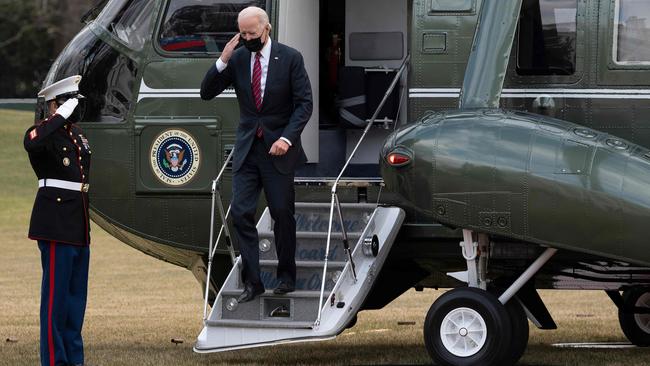 Joe Biden salutes as he arrives at the White House by helicopter on Friday US time. Picture: AFP