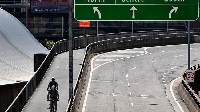 Cyclists make their way through streets empty due to lockdown restrictions. Picture: Saeed Khan/AFP