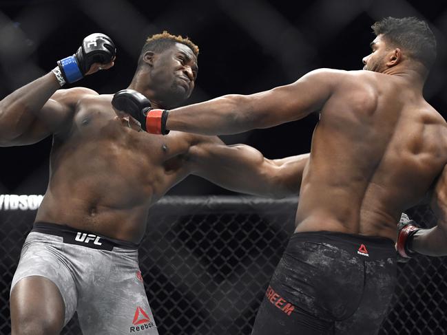 Francis Ngannou, left, hits Alistair Overeem in the first round during a UFC 218 heavyweight mixed martial arts bout, Saturday, Dec. 2, 2017 in Detroit. Ngannou defeated Overeem by first-round knockout. (AP Photo/Jose Juarez)