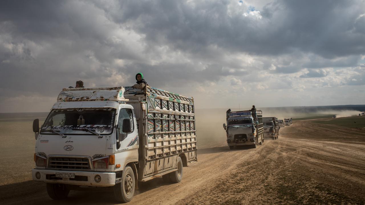 Trucks of civilians who have fled fighting in Bagouz are transported to a camp after being screened by members of the SDF at a makeshift screening point in the desert. Picture: Chris McGrath/Getty Images