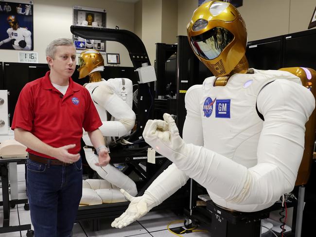 Jonathan Rogers, Robonaut Deputy Project Manager, with Robonaut 2 robots being programmed and tested in the Dexterous Robitics Lab. Picture: Michael Wyke