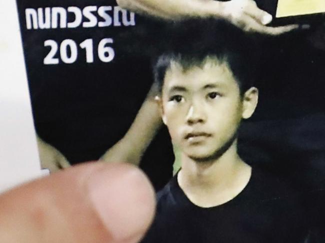 Banphot Konkum, father of Duangpetch Promthep, 13, one of the rescued Thai boys, shows a picture of his son who was in the cave. Picture: AP