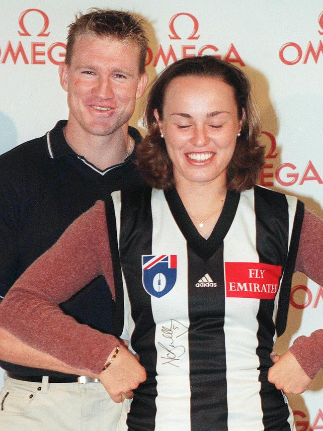 Martina Hingis has a giggle with Bucks in her Pies jumper during the 2000 Australian Open.