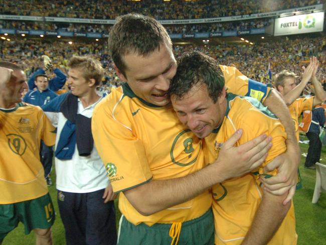 Australia win their World Cup Qualifier with Uraguay at Sydney Olympic Stadium. 16/11/05. Mark Viduka embraces team mate Lucas Neill