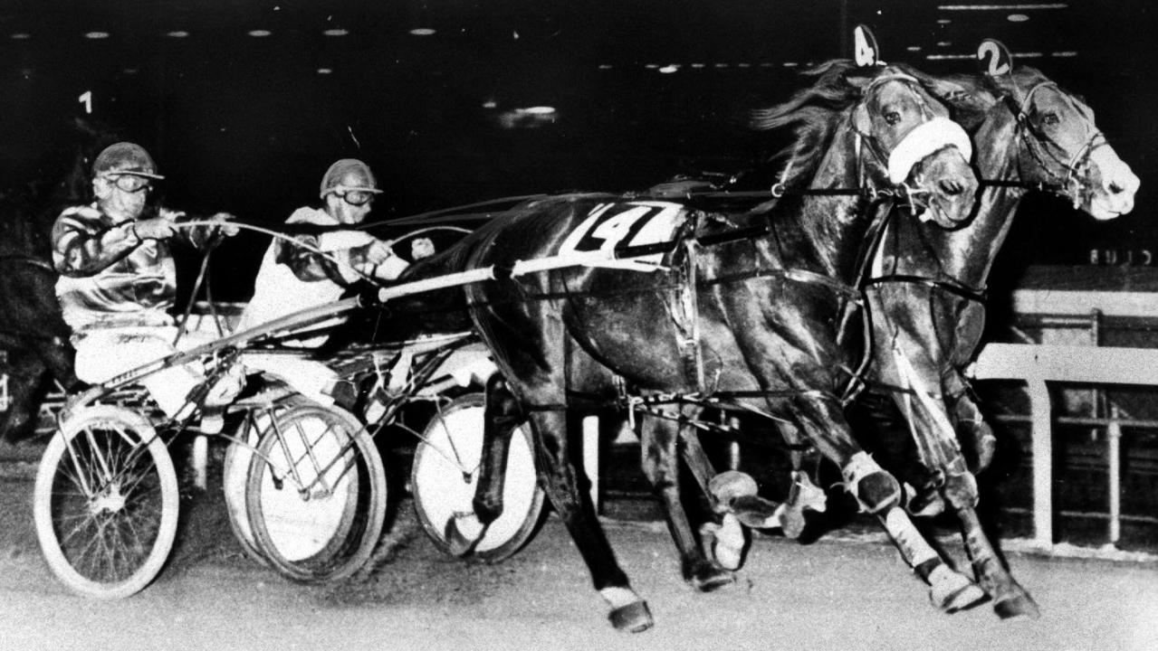 1974. Pacer Hondo Grattan passes Paleface Adios (inside) to win the Miracle Mile.