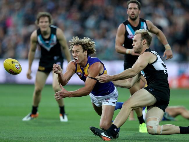 Matt Priddis of the Eagles handballs past Jack Hombsch of the Power.