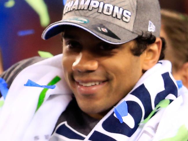 EAST RUTHERFORD, NJ - FEBRUARY 02: Russell Wilson #3 of the Seattle Seahawks celebrates with the Vince Lombardi trophy after defeating the Denver Broncos 43-8 in Super Bowl XLVIII at MetLife Stadium on February 2, 2014 in East Rutherford, New Jersey. (Photo by Rob Carr/Getty Images) ***BESTPIX*** Picture: Images Getty