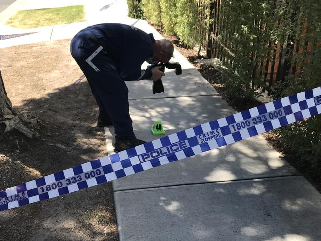 A forensics expert photographing the blood trail. Picture: Wes Hosking