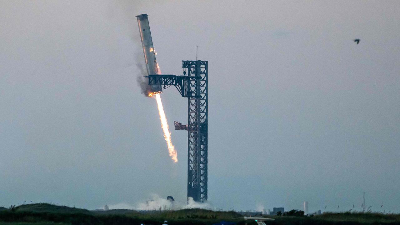 SpaceX successfully "caught" the first-stage booster of its Starship megarocket Sunday as it returned to the launch pad after a test flight. Picture: Sergio Flores/AFP