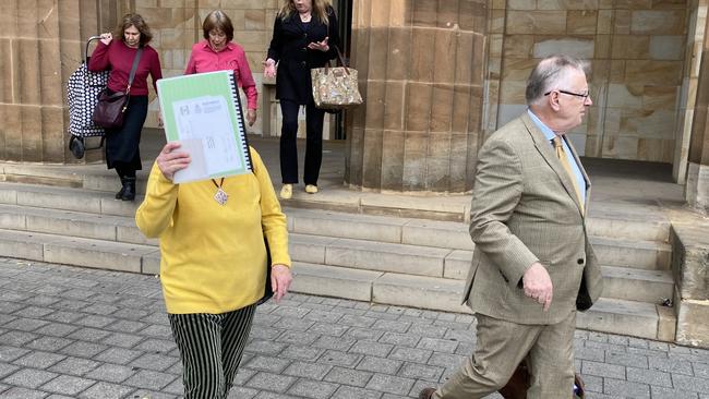 Mary Kolusniewski leaves court after being charged with property damage for painting "WTF" in red paint on council signs. Picture: Kathryn Bermingham