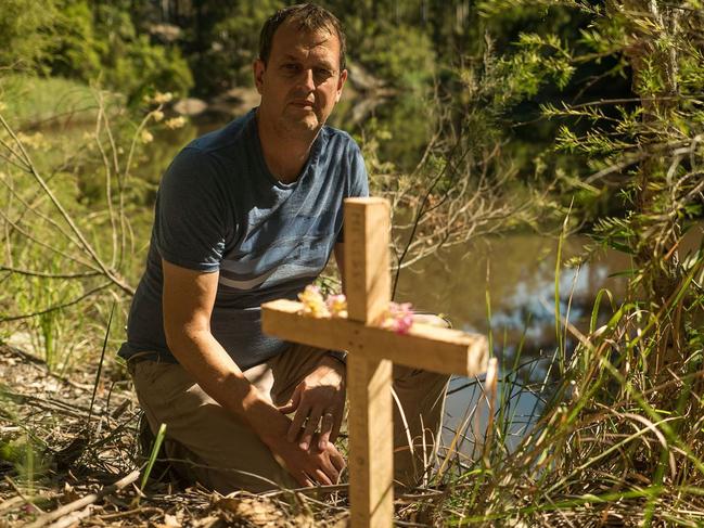 Peter Hallett by a cross at Burrenjim-Dam, where his sister’s body was found.