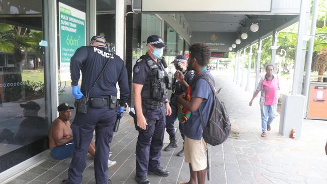 A group of itinerants on Shields St get moved on by Cairns police after illegally consuming alcohol and causing a disturbance. Picture: Peter Carruthers