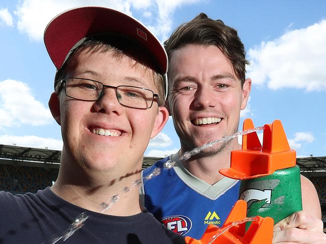 Lachie Neale with assistant coach Jack Baggoley, 19 of Wynnum, who lends a hand at the Brisbane Lions training every Thursday, The Gabba. Photographer: Liam Kidston.