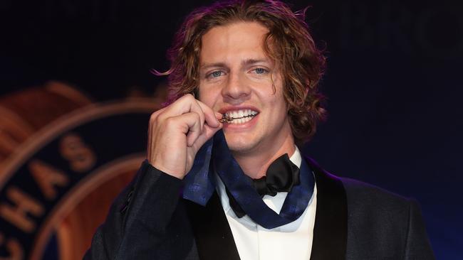 2019 Brownlow winner Nat Fyfe bites the Brownlow Medal. Picture: Michael Klein.