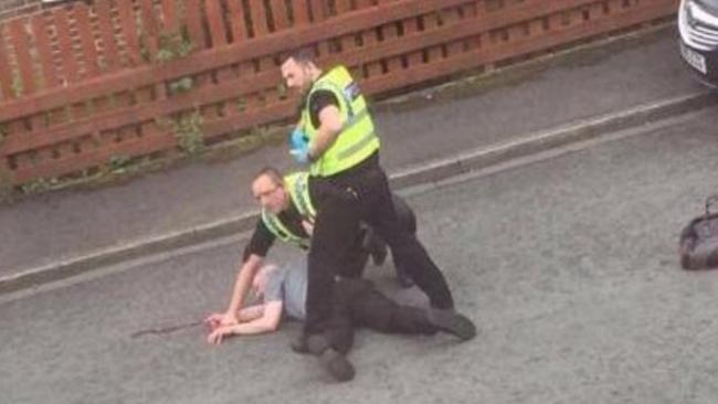 A man is detained near the scene of the attack. Picture: Snapchat