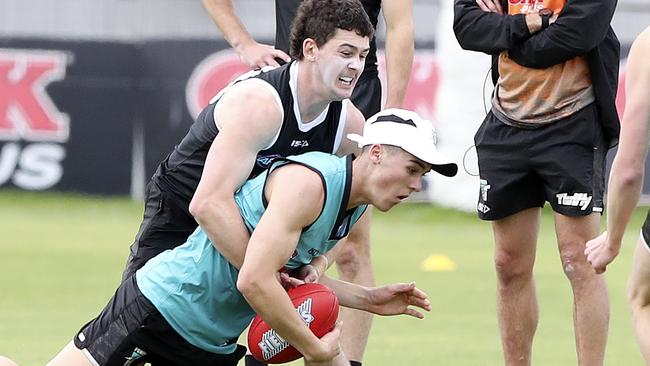 Port Adelaide draftee Connor Rozee is tackled by Darcy Byrne-Jones at Port Adelaide training. Picture: Sarah Reed