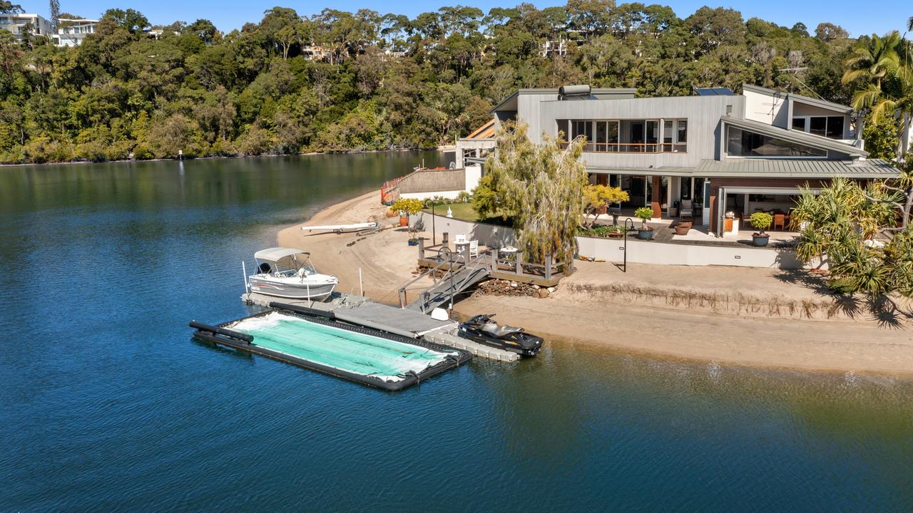 The eye catching home has its own jetty and pontoon.