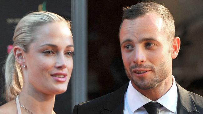 (FILES) In this file photo taken on November 04, 2012 during the Feather Awards held at Melrose Arch in Johannesburg shows South Africa's Olympic sprint star Oscar Pistorius and his model girlfriend Reeva Steenkamp. - South African Paralympic champion Oscar Pistorius might be released from prison this week, a decade after he killed his girlfriend in a crime that gripped the world.  A parole board is to decide whether Pistorius should be let out early, after a hearing in Pretoria on March 31, 2023. (Photo by LUCKY NXUMALO / AFP)