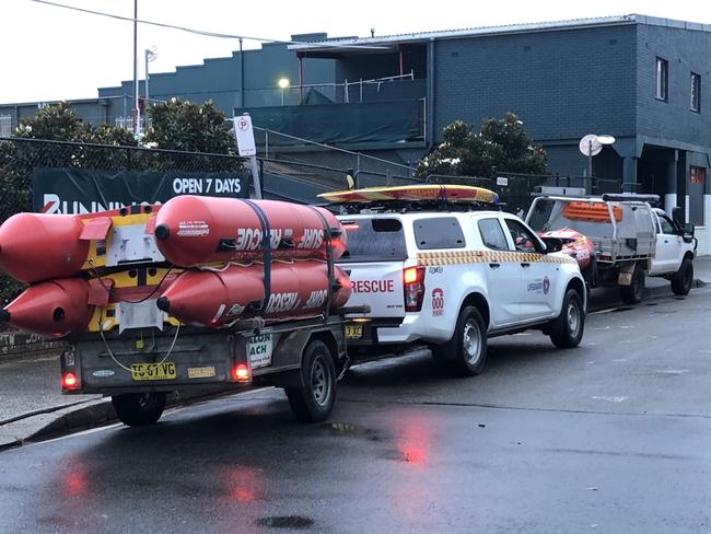 Surf lifesavers from Avalon Beach, Warriewood and Palm Beach arrive in Narrabeen to help. Picture: Jim O'Rourke