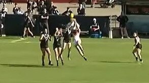 Katelyn Rosenzweig (centre in white) jumps for the ball just before she is injured.