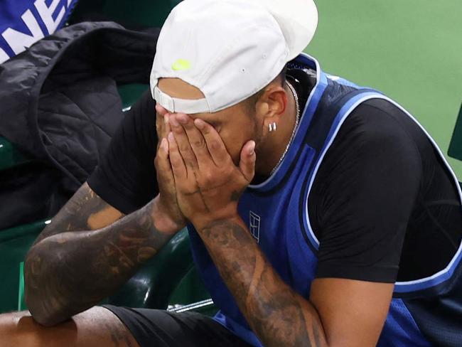 INDIAN WELLS, CALIFORNIA - MARCH 06: Nick Kyrgios of Australia shows his dejection as he is surrounded by medical personel after having to retire due to a wrist injury against Botic Van De Zandschulp of the Netherlands in their first round match during the BNP Paribas Open at Indian Wells Tennis Garden on March 06, 2025 in Indian Wells, California.   Clive Brunskill/Getty Images/AFP (Photo by CLIVE BRUNSKILL / GETTY IMAGES NORTH AMERICA / Getty Images via AFP)