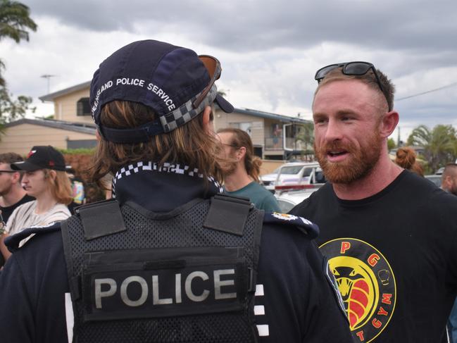 Torin O'Brien speaking with Rockhampton police during the community rally.