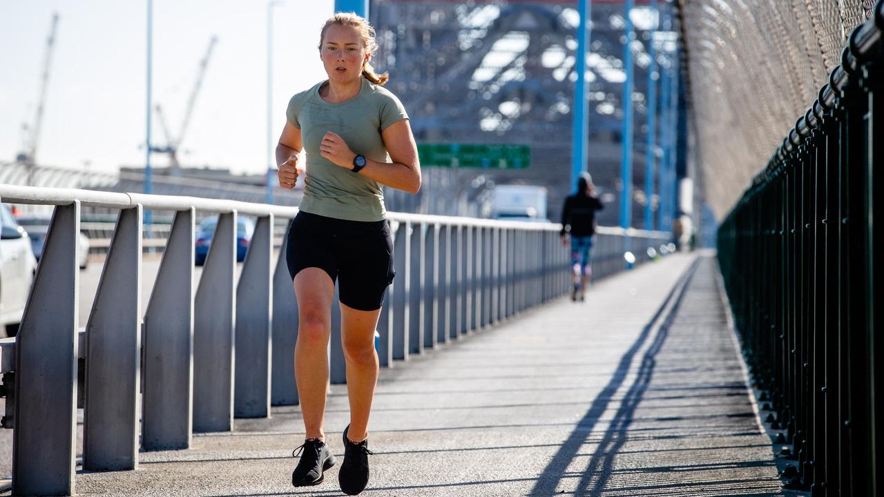 A runner exercises on Story Bridge in Brisbane. Picture: Patrick Hamilton/AFP