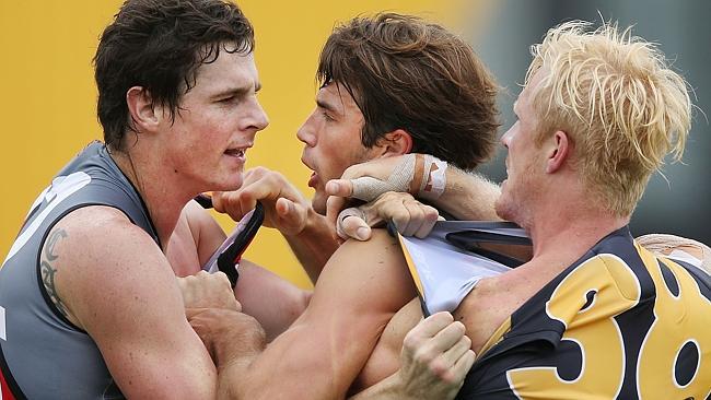 Richmond’s Alex Rance does his best to separate Jake Carlisle and Steve Morris. Photo by 