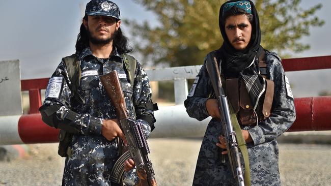 Taliban fighters stand guard at the entrance gate of a police district in Kabul. Picture: AFP