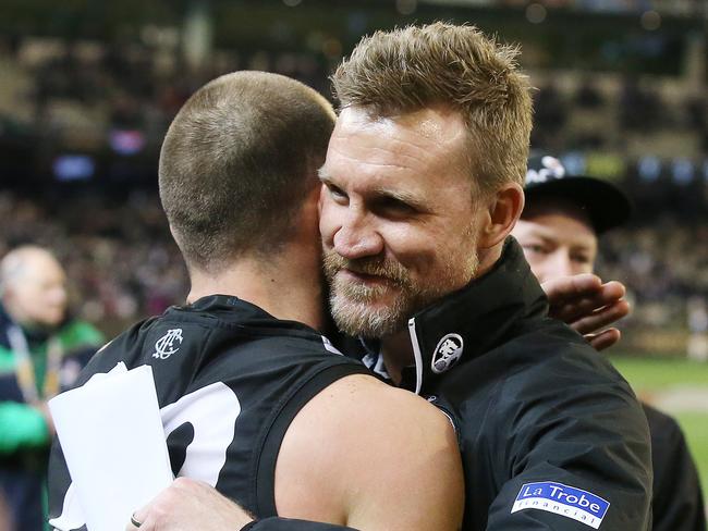 Nathan Buckley shares a hug with Steele Sidebottom after their Giant win. Pic: Michael Klein