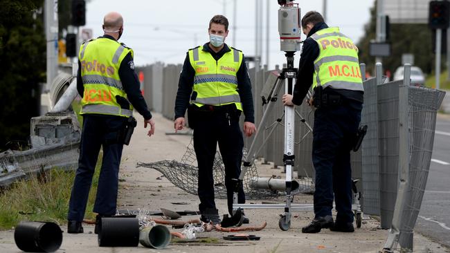 Police inspecting debris from the crash. Picture: Andrew Henshaw