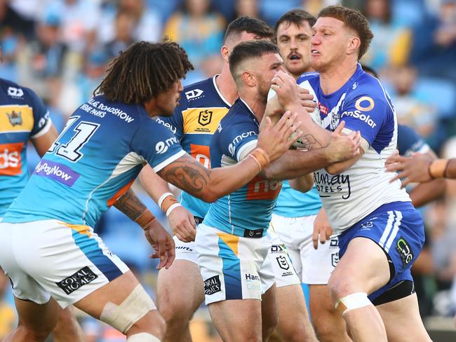 GOLD COAST, AUSTRALIA - MAY 22: Dylan Napa of the Bulldogs is tackled during the round 11 NRL match between the Gold Coast Titans and the Canterbury Bulldogs at Cbus Super Stadium, on May 22, 2021, in Gold Coast, Australia. (Photo by Chris Hyde/Getty Images)