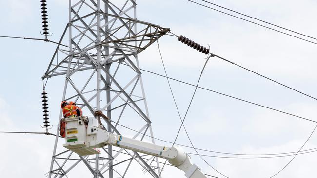 Workers from Endeavour Energy repairing a high-voltage power line that fell over multiple streets and properties around Aquilina Drive at Plumpton. Picture: Jonathan Ng