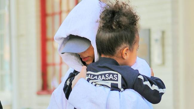 Kim Kardashian runs fearfully to her waiting SUV with a scared looking North West in New York.