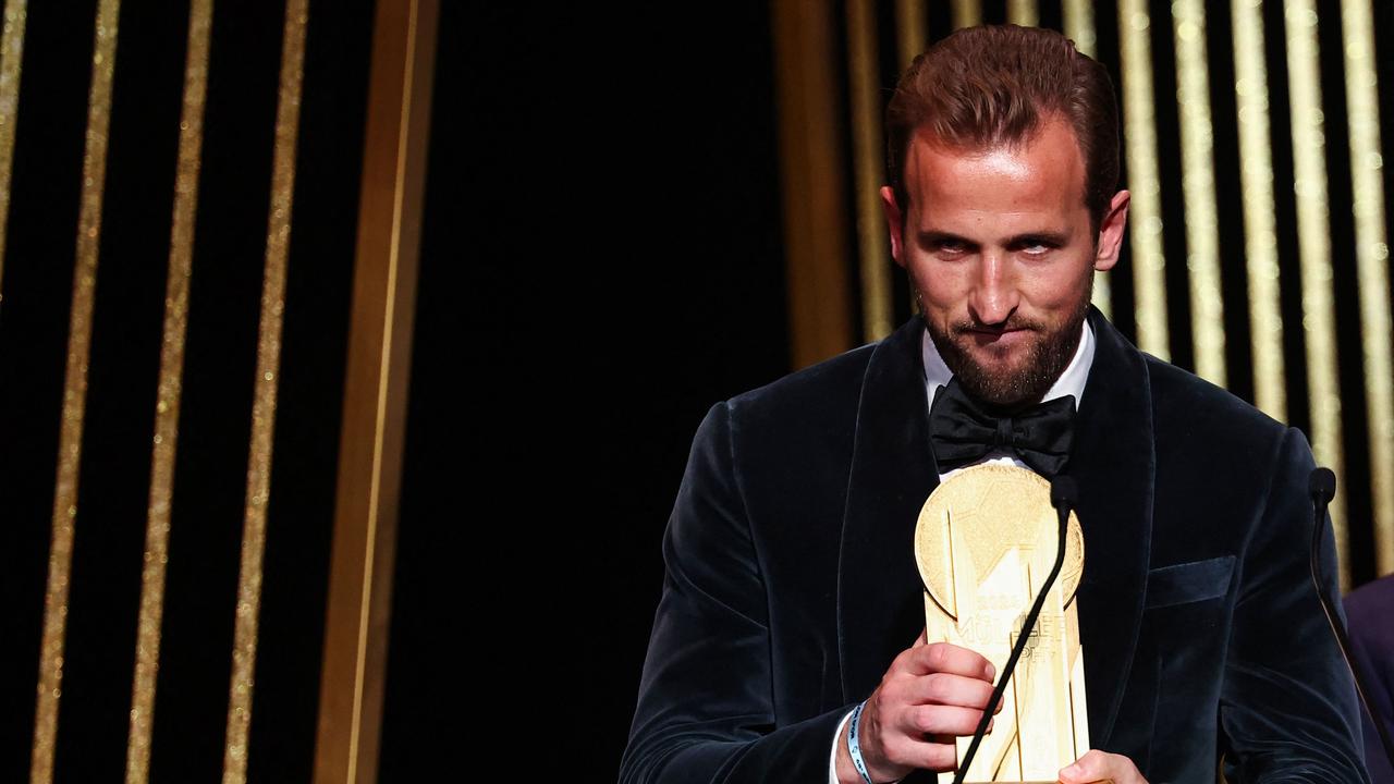 Bayern's English forward Harry Kane and Real Madrid's French forward Kylian Mbappe (unseen) receive the Gerd Muller Trophy for Best Striker. (Photo by FRANCK FIFE / AFP)