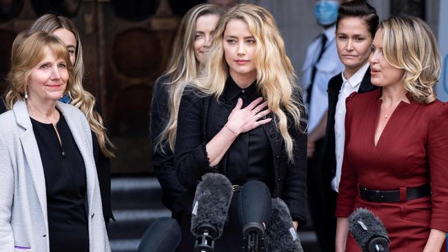 Amber Heard (C) makes a statement to members of the media outside the High Court, following the final day of the libel trial by her former husband Johnny Depp against News Group Newspapers. Picture: AFP.