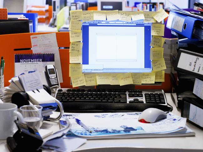 Messy Desk in an Open Plan Office. Must credit Thinkstock