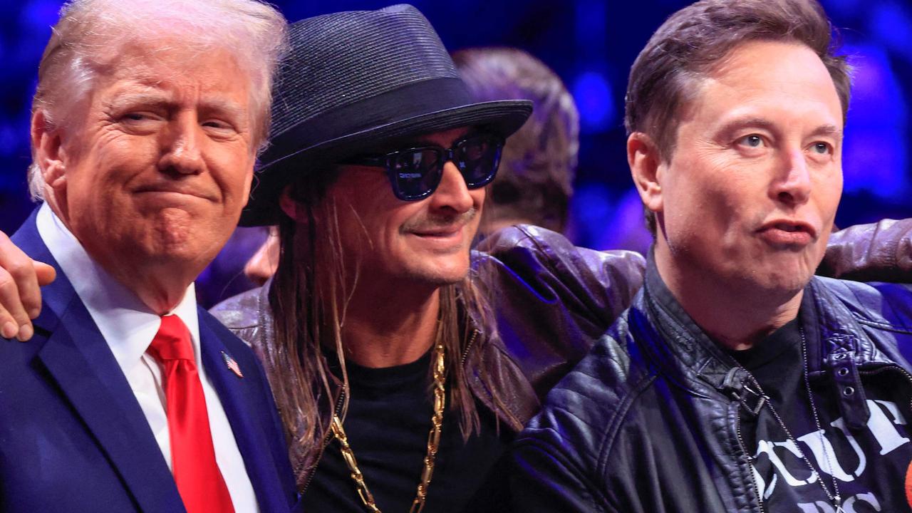 Mr Trump with singer Kid Rock and billionaire Elon Musk at a UFC event yesterday. He appears to be enjoying the post-election period. Picture: Kena Betancur/AFP