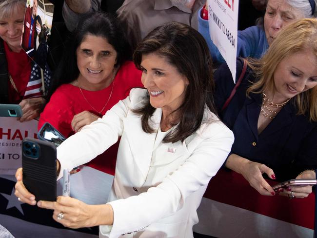 TOPSHOT - Former US ambassador to the UN Nikki Haley poses for a selfie with a crowd of supporters during a campaign event to launch her presidential bid, at the Charleston Visitor Center in Charleston, South Carolina, on February 15, 2023. - Haley announced on February 14 she is running for president in 2024, becoming the first high-profile candidate to challenge former President Donald Trump for the Republican nomination. (Photo by Logan Cyrus / AFP)